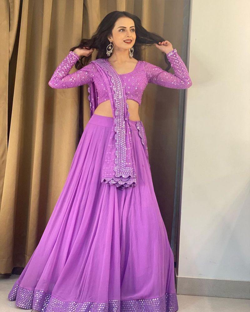 Cape style Lehenga choli, Lehenga choli in dark shades, Handloom Lehenga choli, Lehenga choli with asymmetrical hem, Lehenga choli for vacation, Lehenga choli with gold foil work, Convertible Lehenga choli, Lehenga choli with halter neck, Mirror embroidered Lehenga choli, Lehenga choli with scalloped edges